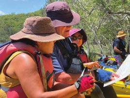 Paddlers in kayaks reading a map